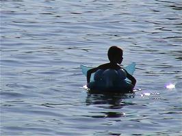 A child has fun in the safe waters of Lake Geneva at La Chamberonne, Lausanne